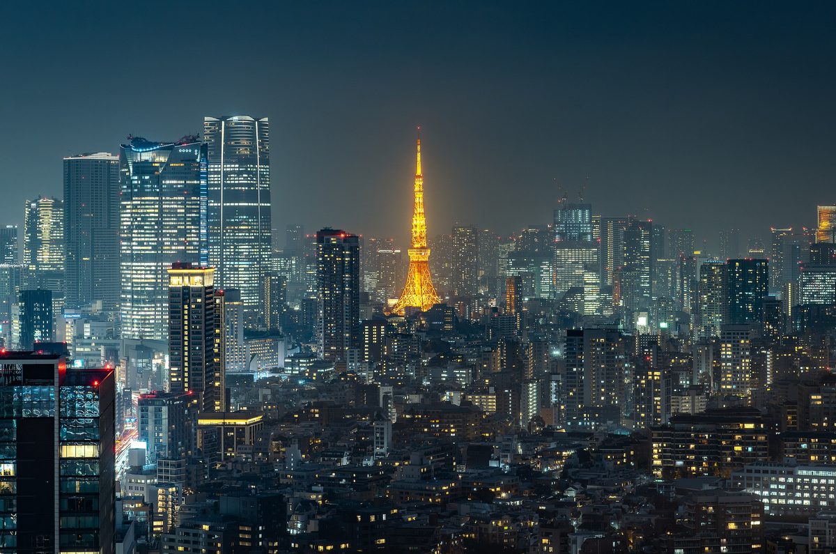 Tokyo Tower lit above the Minato City skyline after dark